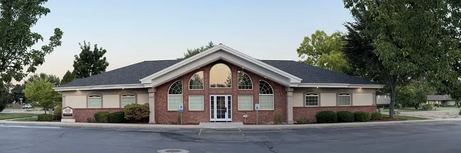 Times Square Dental and its car park, framed by trees, on Times Square Court in Boise.